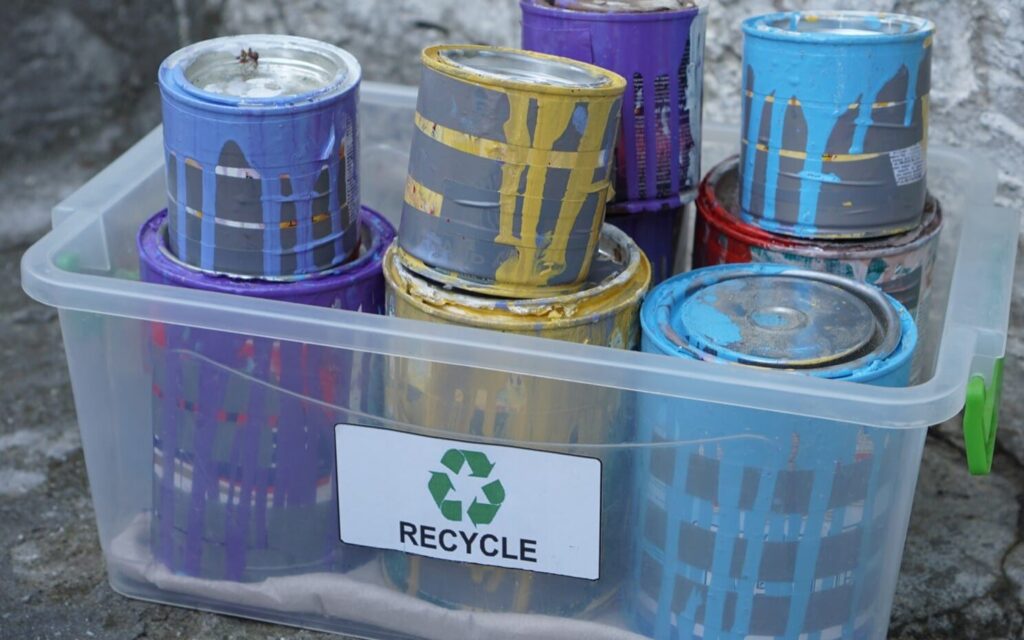 used paint cans in bin for recycling