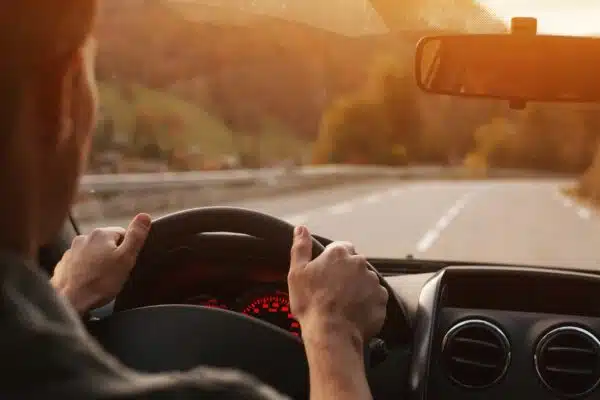 image of a guy traveling by car, on a road trip with a view of the road
