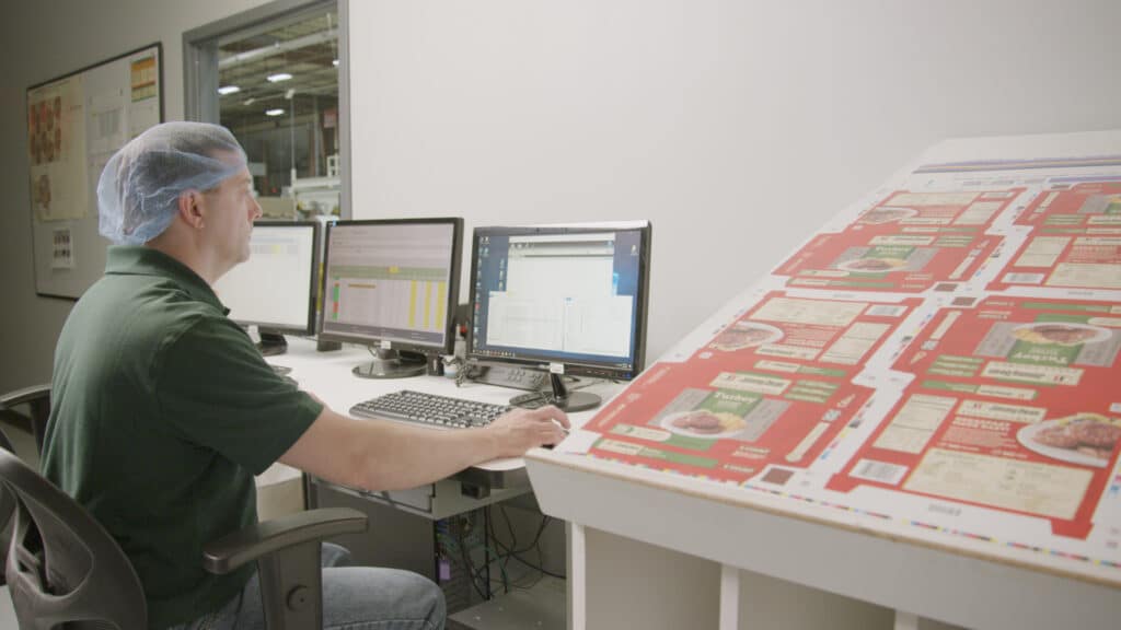 Man working on computers at the Syracuse